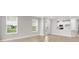 Bright open living area featuring hardwood flooring and abundant natural light from large windows at 3142 Torta Ct, Bradenton, FL 34211