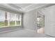 Bright main bedroom with carpet, a trey ceiling, and large windows overlooking the backyard at 3142 Torta Ct, Bradenton, FL 34211
