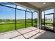 Screened-in patio with brick flooring overlooking beautiful green lawn and pond at 3142 Torta Ct, Bradenton, FL 34211