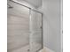 Modern shower with sliding glass door and stone tiling at 3142 Torta Ct, Bradenton, FL 34211