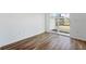 Bright room boasts hardwood floors and sliding glass doors to private patio at 6162 Daerr Ridge St, Zephyrhills, FL 33542