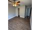 Bright bedroom featuring hardwood floors, a ceiling fan, and closet storage at 845 18Th S Ave, St Petersburg, FL 33705