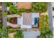 Aerial view of the home showcasing the roof, landscaped grounds, driveway, and enclosed pool area at 5108 Saint Albans Ave, Siesta Key, FL 34242