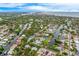 Expansive aerial shot of the neighborhood, highlighting waterfront living, lush trees, and ocean views at 5108 Saint Albans Ave, Siesta Key, FL 34242