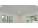 Bedroom with two windows providing ample natural light, highlighting the crown moulding at 5108 Saint Albans Ave, Siesta Key, FL 34242