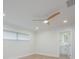 Bright bedroom features wood floors, a modern ceiling fan, and ensuite bathroom access at 5108 Saint Albans Ave, Siesta Key, FL 34242