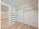 Spacious walk-in closet featuring custom built-in shelving, ample storage space and natural light at 5108 Saint Albans Ave, Siesta Key, FL 34242
