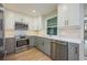 Updated kitchen with stainless steel appliances, modern backsplash, countertops, and stylish cabinets at 5108 Saint Albans Ave, Siesta Key, FL 34242