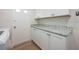 Laundry room with custom countertop and blue cabinet hardware at 5108 Saint Albans Ave, Siesta Key, FL 34242