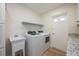 Well-equipped laundry room with modern appliances, utility sink and plenty of counter space for convenience at 5108 Saint Albans Ave, Siesta Key, FL 34242
