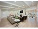 Spacious and bright living room with fireplace, wood floors, white ceilings, and seamless flow to the dining area at 5108 Saint Albans Ave, Siesta Key, FL 34242