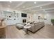 Bright and spacious living room features a fireplace, white beamed ceilings, built-in shelving, and wood floors at 5108 Saint Albans Ave, Siesta Key, FL 34242