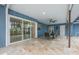 Covered patio area features travertine flooring, ceiling fan, and sliding glass doors to the pool area at 5108 Saint Albans Ave, Siesta Key, FL 34242