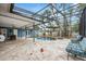 Stunning covered pool area with stylish seating, a tranquil water feature, and lush tropical landscaping at 5108 Saint Albans Ave, Siesta Key, FL 34242