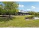 Beautiful townhouse backyard with screened in porch overlooking a pond with well maintained lawn at 10124 Westpark Preserve Blvd, Tampa, FL 33625