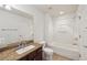 Bright bathroom features granite countertop, wood cabinets, bathtub and shower combo at 10124 Westpark Preserve Blvd, Tampa, FL 33625