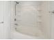Bathroom features a shower-tub combo with a white shower curtain and built-in shelves at 10124 Westpark Preserve Blvd, Tampa, FL 33625