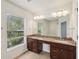 Bathroom features a double vanity with ample counter space, dark wood cabinets, and large mirror at 10124 Westpark Preserve Blvd, Tampa, FL 33625