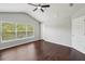 Bright primary bedroom with vaulted ceiling, hardwood floors and a large window with natural light at 10124 Westpark Preserve Blvd, Tampa, FL 33625