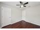 Bedroom features a ceiling fan, hardwood floor, and multiple doors at 10124 Westpark Preserve Blvd, Tampa, FL 33625