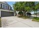 Well-maintained townhome with a spacious driveway and lush landscaping, enhancing curb appeal at 10124 Westpark Preserve Blvd, Tampa, FL 33625