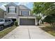 Two-story townhome featuring a two car garage and neutral paint, complemented by a well-manicured lawn at 10124 Westpark Preserve Blvd, Tampa, FL 33625