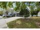Charming townhome featuring a two-car garage, driveway, and well-kept lawn with mature trees at 10124 Westpark Preserve Blvd, Tampa, FL 33625
