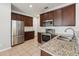 Modern kitchen with stainless steel appliances, granite countertops, and rich cabinetry, ready for culinary adventures at 10124 Westpark Preserve Blvd, Tampa, FL 33625