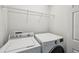 Laundry room with a washer and dryer and storage shelves at 10124 Westpark Preserve Blvd, Tampa, FL 33625