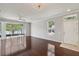 Bright living room with hardwood floors, large windows, and access to a screened lanai, ideal for relaxation and gatherings at 10124 Westpark Preserve Blvd, Tampa, FL 33625