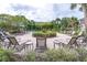 Community pool area with lounge chairs, landscaping, umbrellas and shaded seating area at 10124 Westpark Preserve Blvd, Tampa, FL 33625