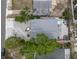 Aerial view of property with backyard, hot tub, shed, and lush green trees, perfect for outdoor living at 135 Florida Blvd, Crystal Beach, FL 34681