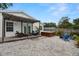 Backyard with hot tub, comfortable seating, and a charming pergola, perfect for outdoor relaxation at 135 Florida Blvd, Crystal Beach, FL 34681