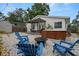 Inviting backyard with a hot tub, fire pit, and comfortable Adirondack chairs for cozy outdoor gatherings at 135 Florida Blvd, Crystal Beach, FL 34681
