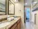 Elegant bathroom with double sinks, granite countertops, and a well-lit vanity area, combining style and functionality at 135 Florida Blvd, Crystal Beach, FL 34681