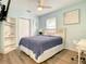 Cozy bedroom with modern furnishings, including a comfortable bed, sleek desk, and ample storage space at 135 Florida Blvd, Crystal Beach, FL 34681
