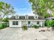 Charming single-story home with light turquoise shutters and light-colored gravel landscaping at 135 Florida Blvd, Crystal Beach, FL 34681