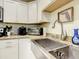 Bright kitchen features stainless sink, granite countertops, and modern appliances at 135 Florida Blvd, Crystal Beach, FL 34681