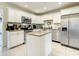 Well-equipped kitchen featuring stainless steel appliances, granite counters, and center island at 135 Florida Blvd, Crystal Beach, FL 34681