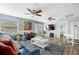 Bright living room with modern furnishings, ceiling fans and stylish decor, perfect for relaxation and entertaining at 135 Florida Blvd, Crystal Beach, FL 34681