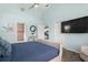 View of the main bedroom showcasing ensuite access, closet, and TV at 135 Florida Blvd, Crystal Beach, FL 34681
