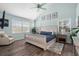 Bright main bedroom with a vaulted ceiling, wood floors, and ensuite bath at 135 Florida Blvd, Crystal Beach, FL 34681