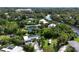 Aerial view of home surrounded by lush greenery, featuring solar panels and a beautiful natural landscape at 2408 Nassau St, Sarasota, FL 34231