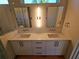 Elegant bathroom showcasing a double vanity with modern fixtures and stylish lighting at 2408 Nassau St, Sarasota, FL 34231