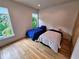 Bright bedroom with hardwood floors, twin beds, and large windows providing scenic views at 2408 Nassau St, Sarasota, FL 34231