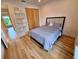 Comfortable bedroom featuring a padded headboard, hardwood floors and direct access to the bathroom at 2408 Nassau St, Sarasota, FL 34231