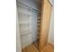 Standard closet featuring shelves and hanging storage, paired with a sliding wooden door at 2408 Nassau St, Sarasota, FL 34231