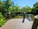 Wooden dock with sturdy posts offers access to the waterfront and serene water views at 2408 Nassau St, Sarasota, FL 34231