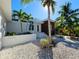 Modern home with lush landscaping, white gravel, and a paver walkway leading to the front door at 2408 Nassau St, Sarasota, FL 34231