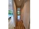 Hallway featuring hardwood floors and views of the pool through the living area's glass doors at 2408 Nassau St, Sarasota, FL 34231